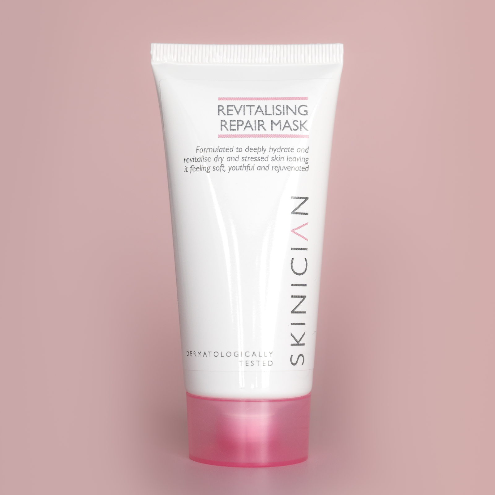 Revitalising Repair Mask tube on a pink background