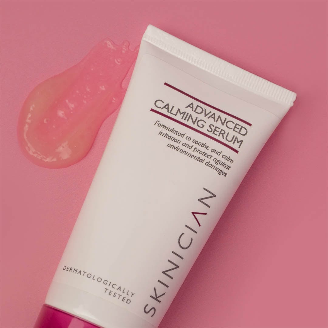 Tube of Skinician Advanced Calming Serum on a pink background