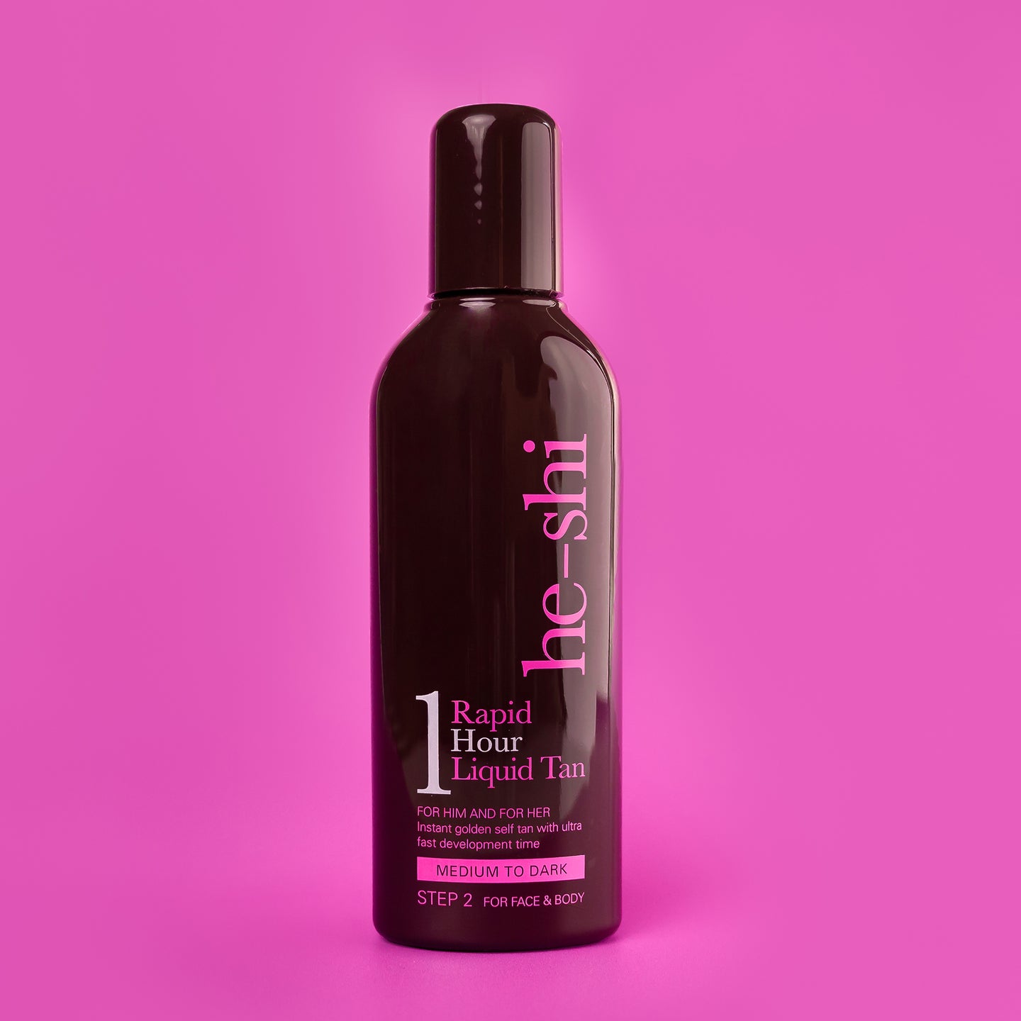 Bottle of he-shi Rapid Hour Liquid Tan on a pink background
