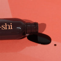 Image of He-Shi Dark Express Liquid Tan bottle on its side the product out