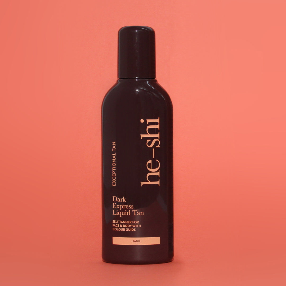 Bottle of he-shi Dark Express Liquid Tan on a coral background