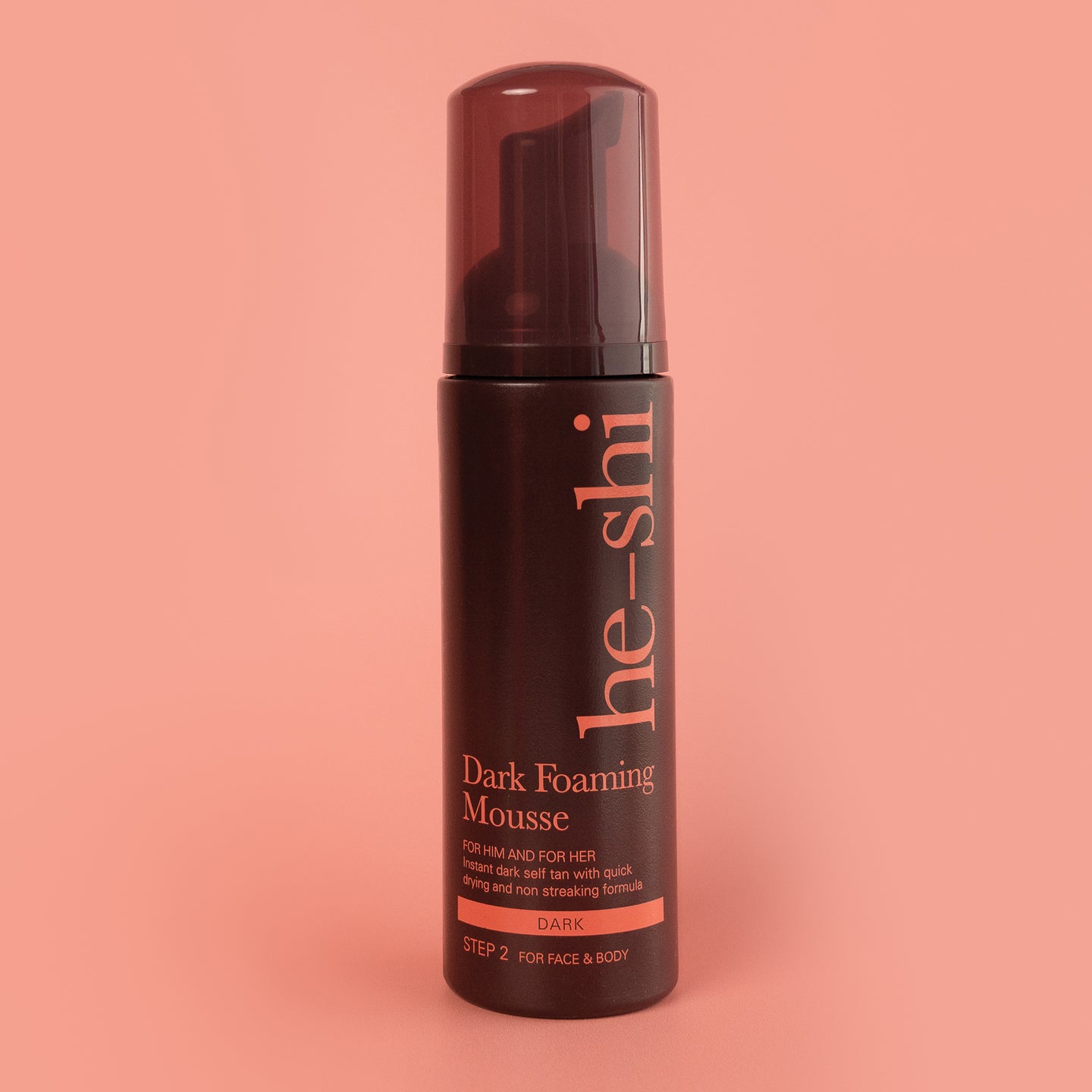 Image of Dark Foaming Mousse bottle on peach background