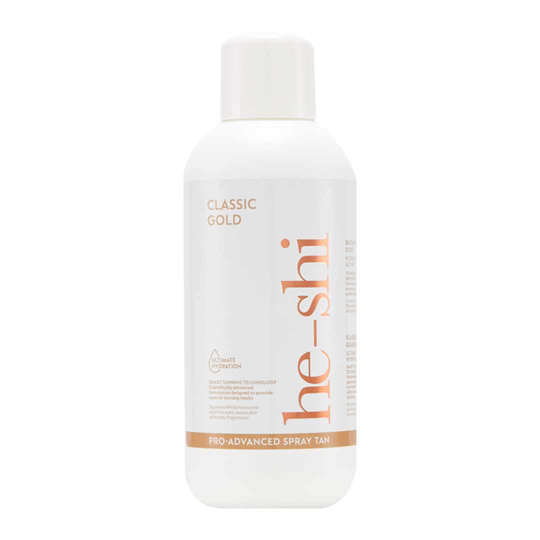 White spray tan bottle labeled 'he-shi Classic Gold' on a white background