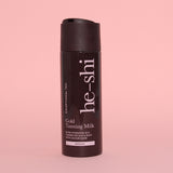 He-Shi Gold Tanning Milk bottle on pink background