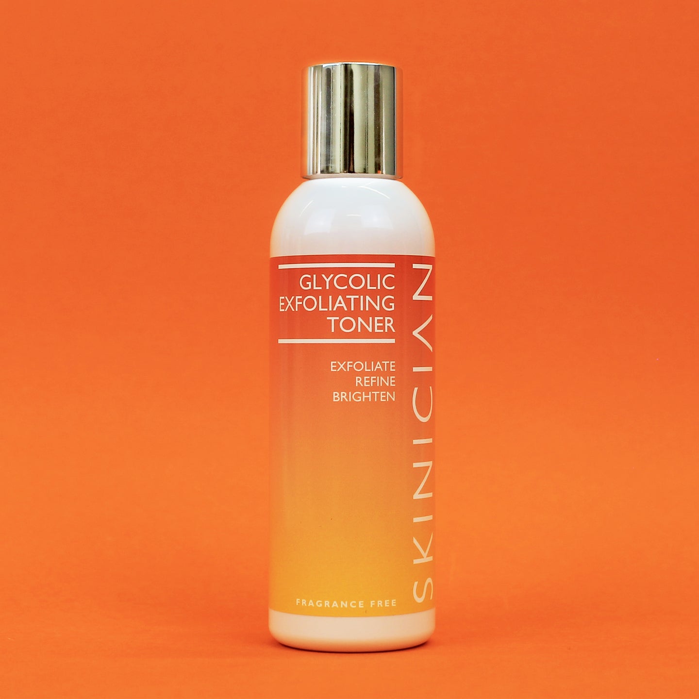Skinician Glycolic Exfoliating Toner bottle on an orange background
