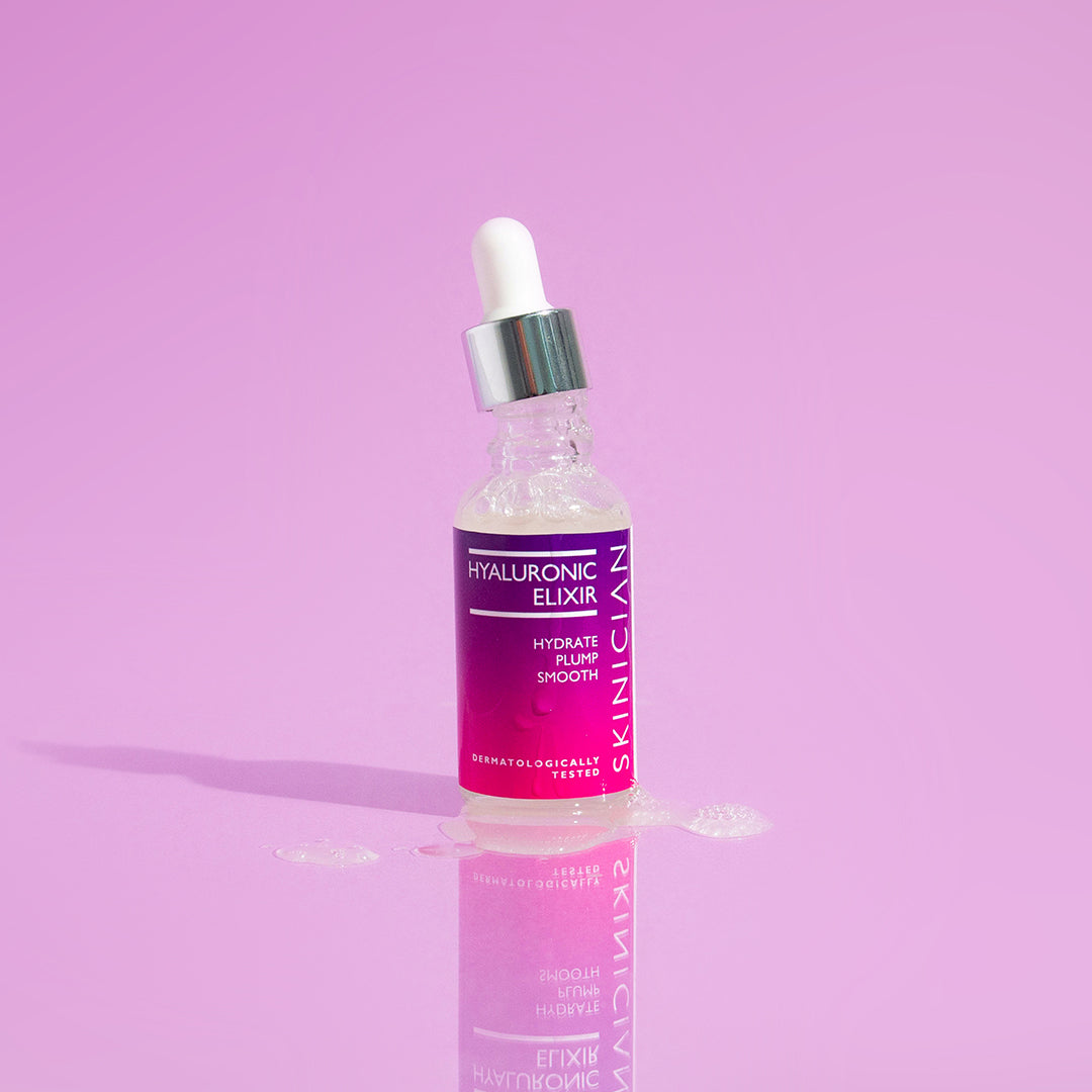 Skinician Hyaluronic Elixir dropper bottle on a purple background