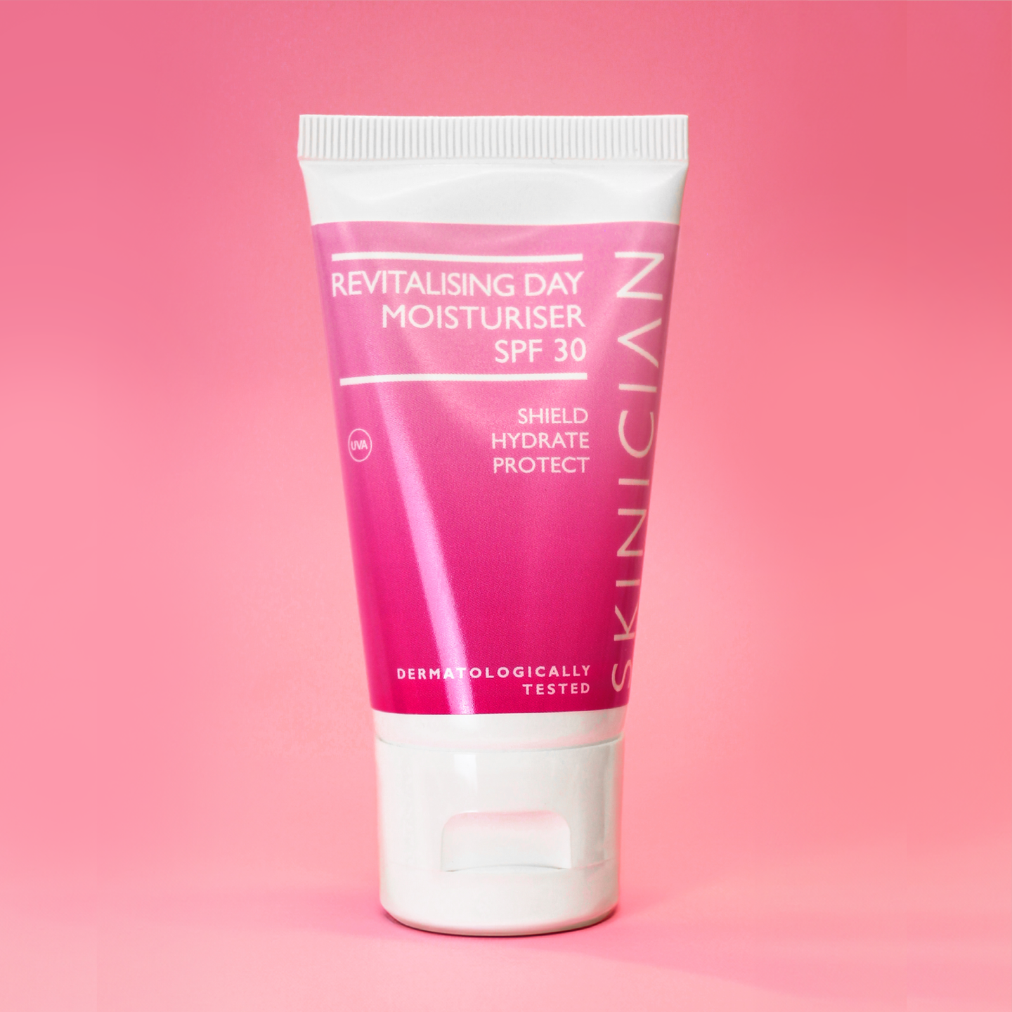 Tube of Skinician revitalising day moisturiser SPF 30 on a pink background