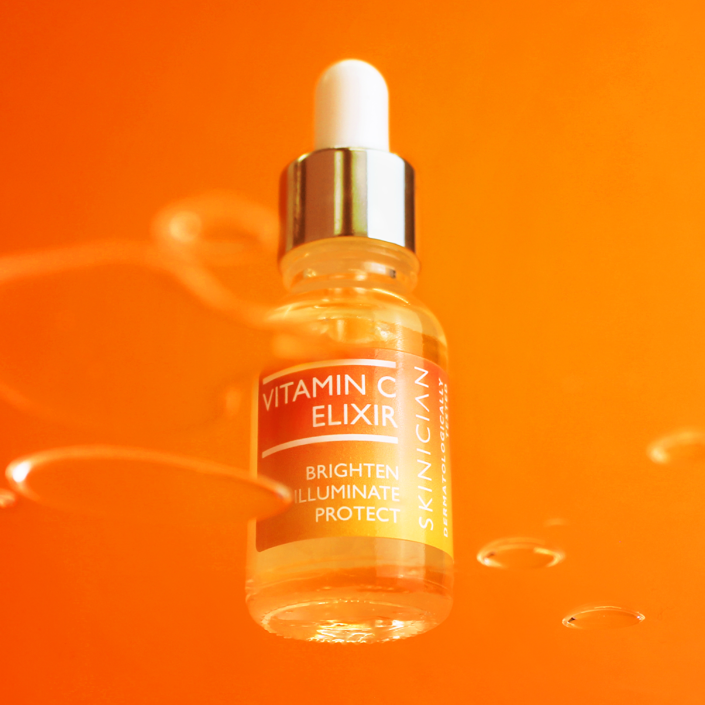 Vitamin C elixir bottle with dropper on an orange background