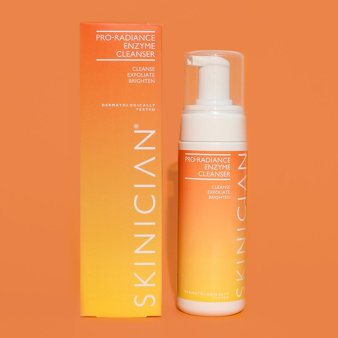 SKINICIAN Pro-Radiance Enzyme Cleanser bottle and packaging on an orange background