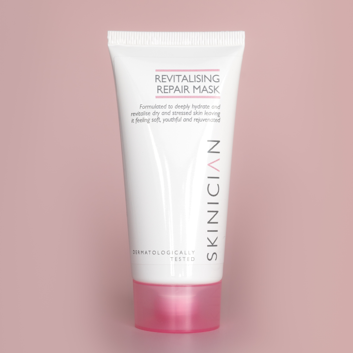 Revitalising Repair Mask tube on a pink background