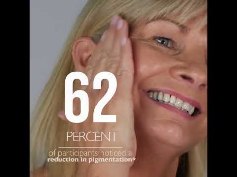 Vitamin C Elixir YouTube video, showing a lady apply the oil onto her face and blend into the skin with her fingertips.  Results in 4 weeks with oranges is overlayed as text.
