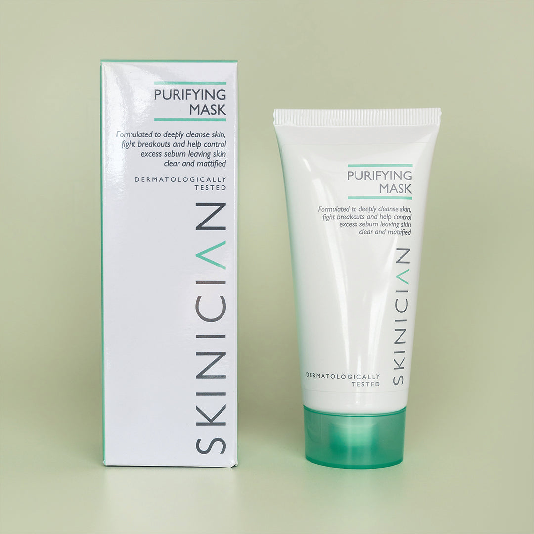 Purifying clay mask tube and box on light green background